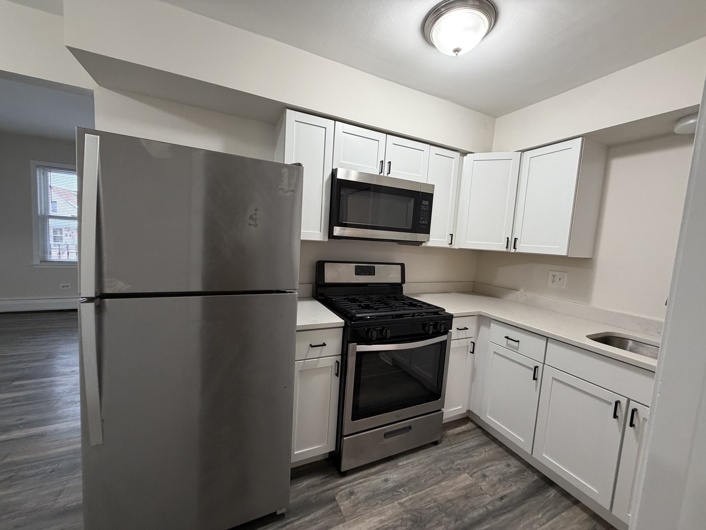 5331 South Kilbourn Avenue, Unit 6 Chicago, IL 60632 - Photo 6 of 11 a kitchen with a refrigerator stove and microwave