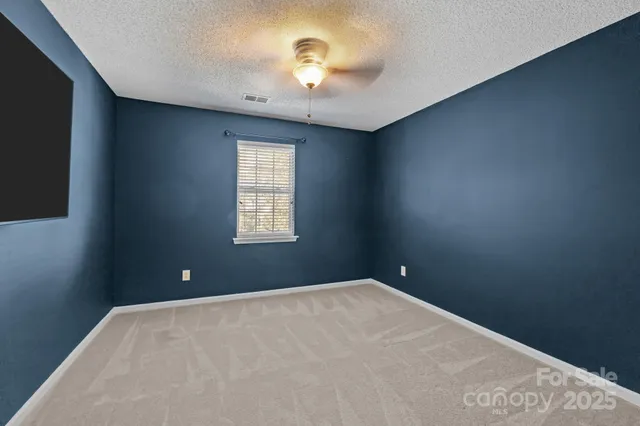 a view of a livingroom with an empty space and a ceiling fan