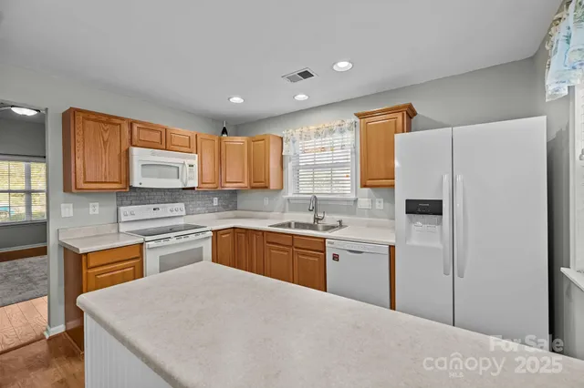 a view of a dining room with furniture a chandelier and wooden floor