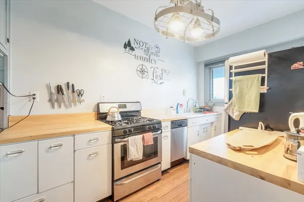 a kitchen with a sink stove and cabinets