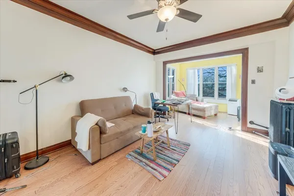 a living room with furniture and a chandelier