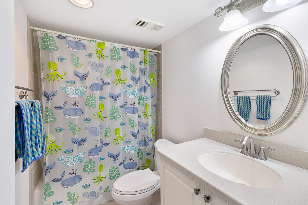 400 Ocean Trail Way, Unit 1108 Jupiter, FL 33477 - Photo 25 of 41 a bathroom with a sink a toilet and shower curtain