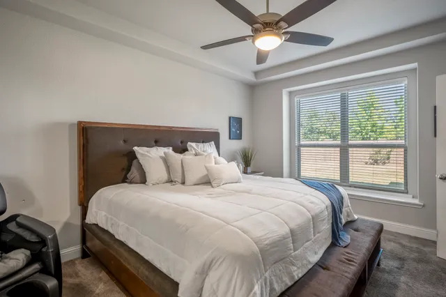 a bedroom with a bed and a chandelier