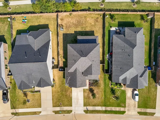 an aerial view of residential houses with outdoor space