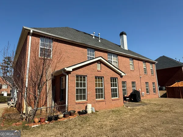 a front view of a house with cars
