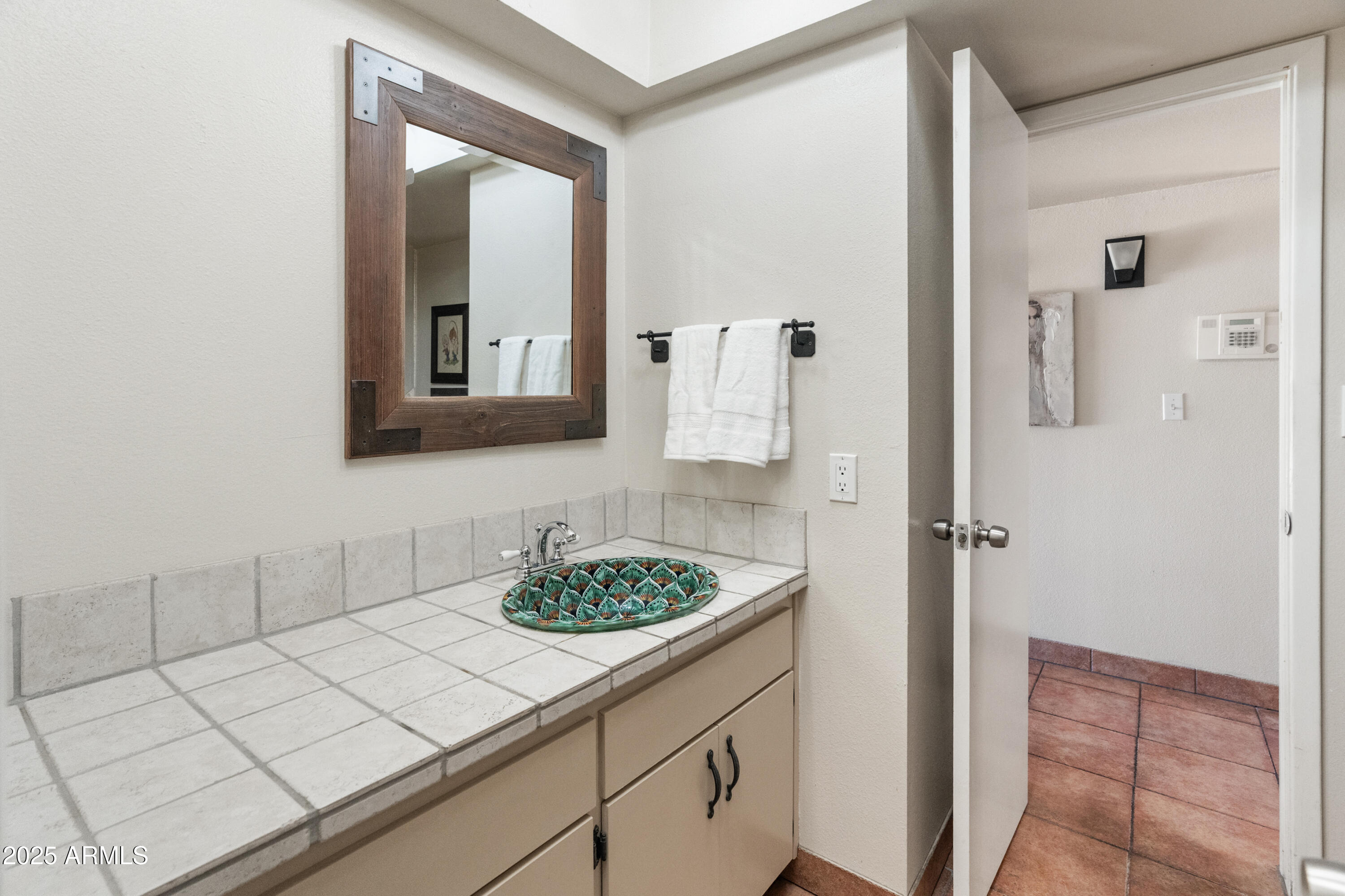 6931 East Pershing Avenue Scottsdale, AZ 85254 - Photo 18 of 59 a bathroom with a sink and a mirror