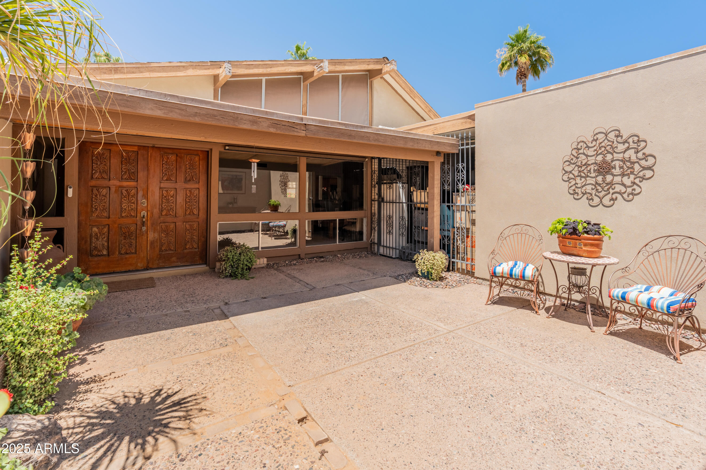 6931 East Pershing Avenue Scottsdale, AZ 85254 - Photo 2 of 59 a front view of a house with outdoor seating and a patio