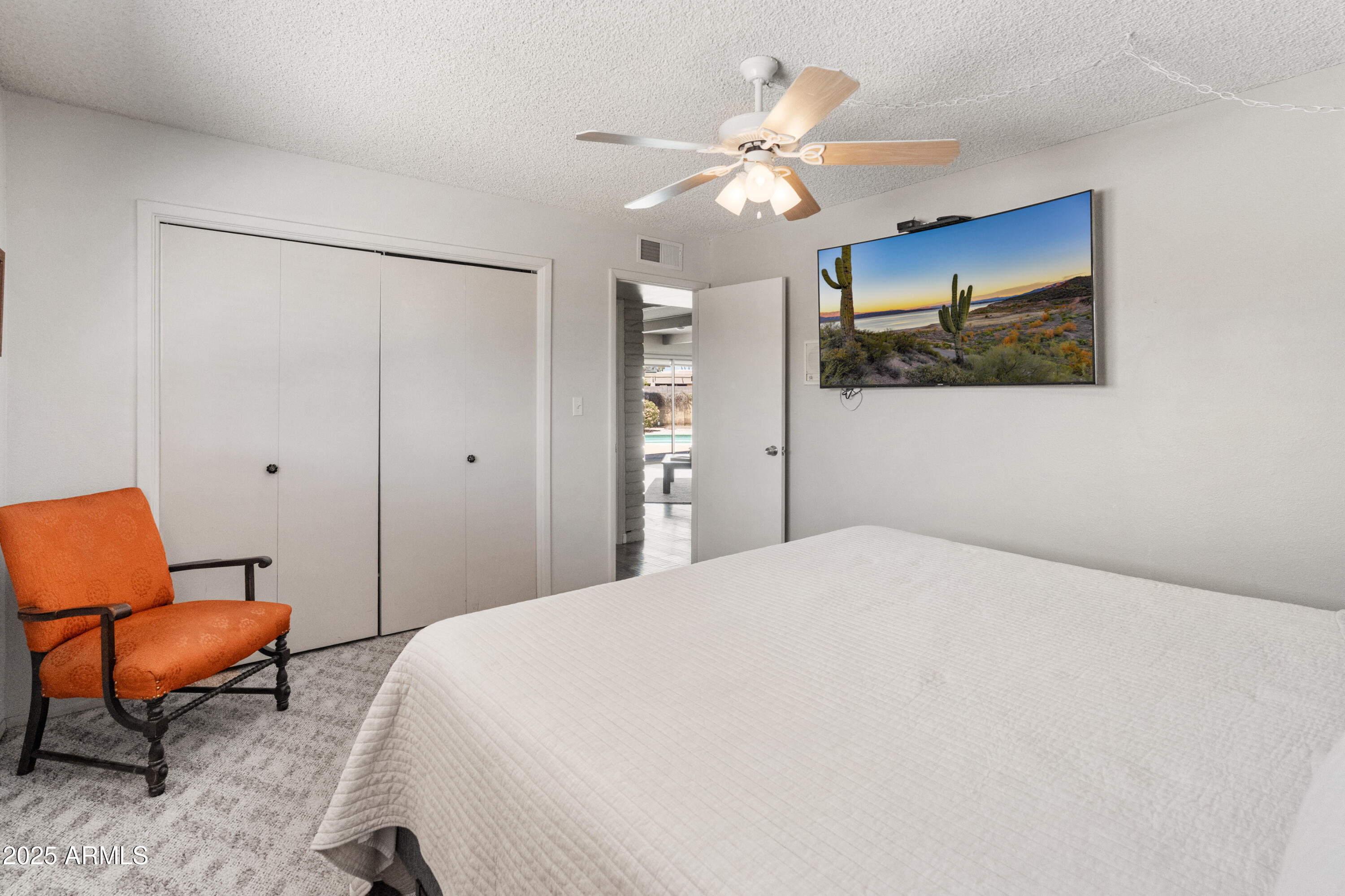 6931 East Pershing Avenue Scottsdale, AZ 85254 - Photo 23 of 59 a bedroom with a bed and a chandelier