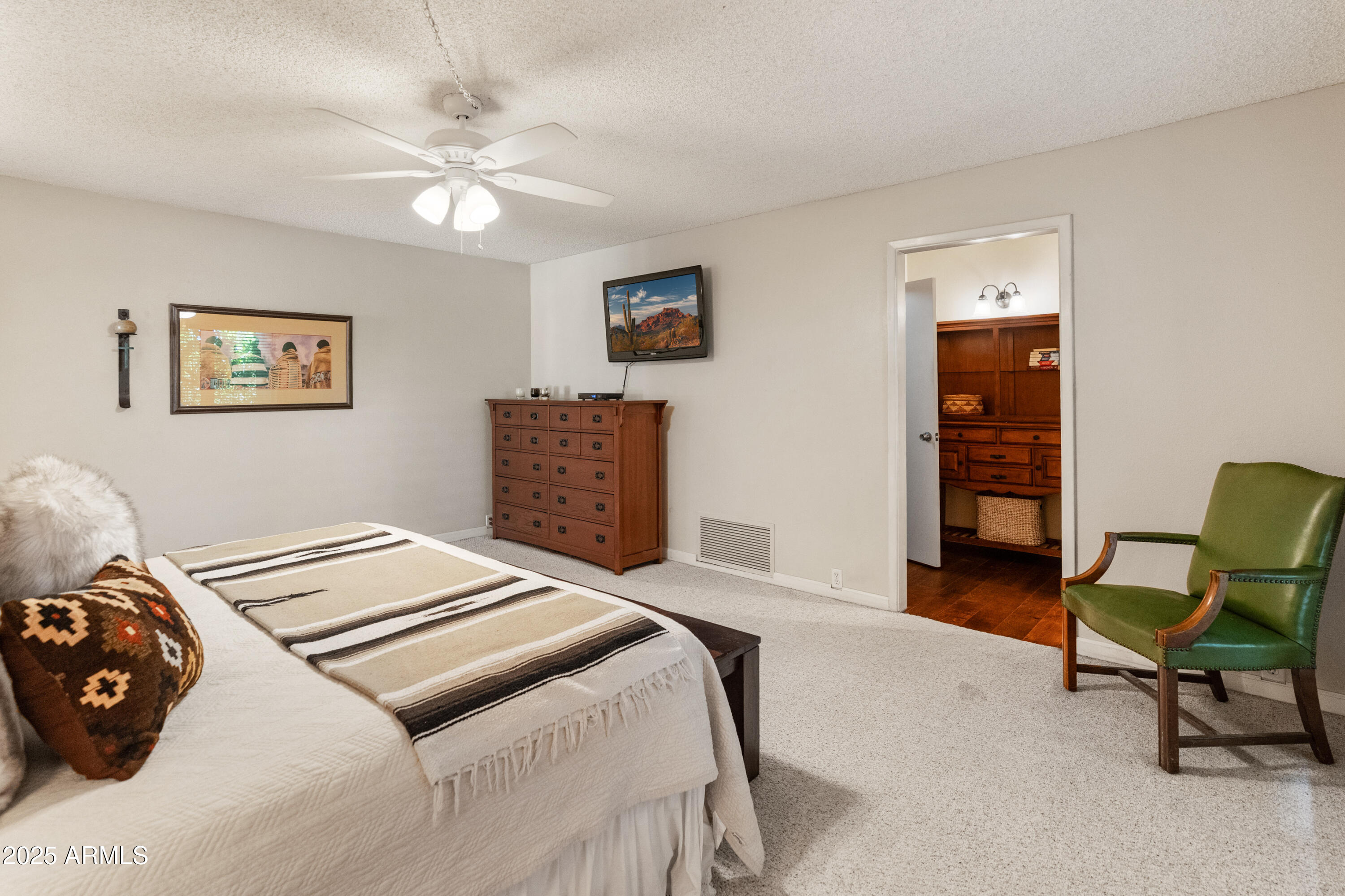 6931 East Pershing Avenue Scottsdale, AZ 85254 - Photo 25 of 59 a bedroom with a bed and a chair