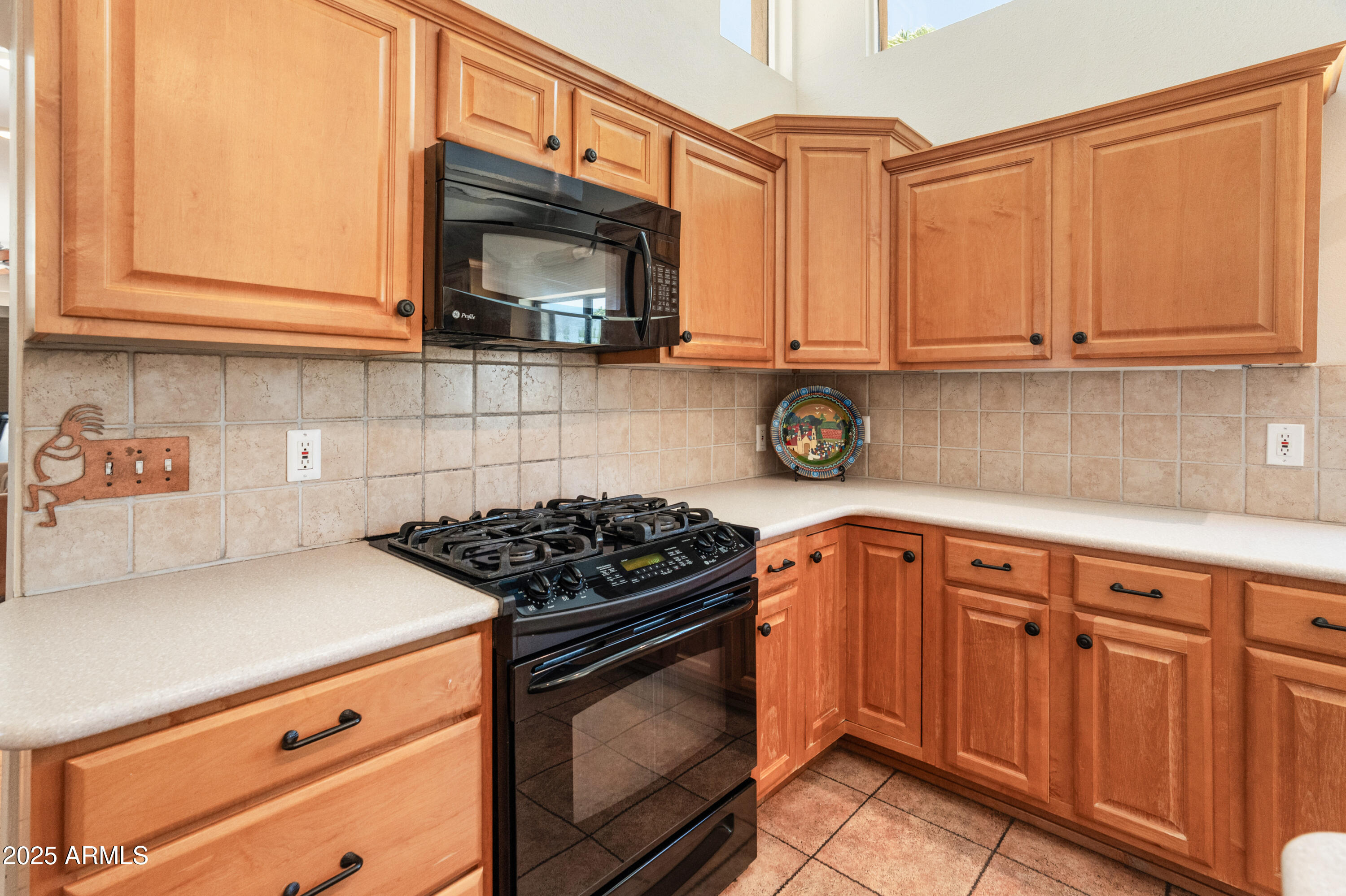 6931 East Pershing Avenue Scottsdale, AZ 85254 - Photo 36 of 59 a kitchen with stainless steel appliances granite countertop a stove a sink and a microwave