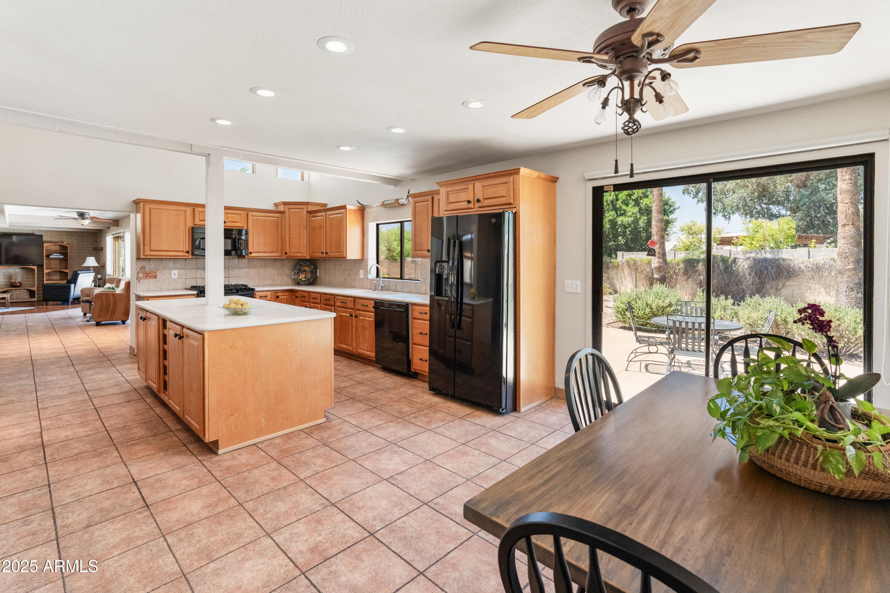 6931 East Pershing Avenue Scottsdale, AZ 85254 - Photo 38 of 59 a kitchen with stainless steel appliances granite countertop a stove a refrigerator a table and chairs with wooden floor