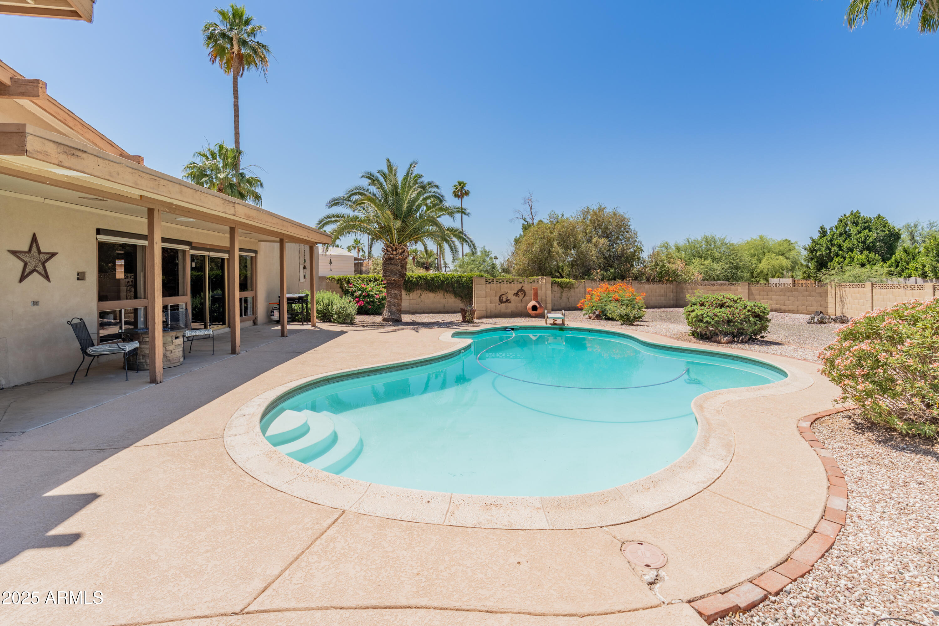 6931 East Pershing Avenue Scottsdale, AZ 85254 - Photo 45 of 59 a view of a swimming pool with outdoor seating