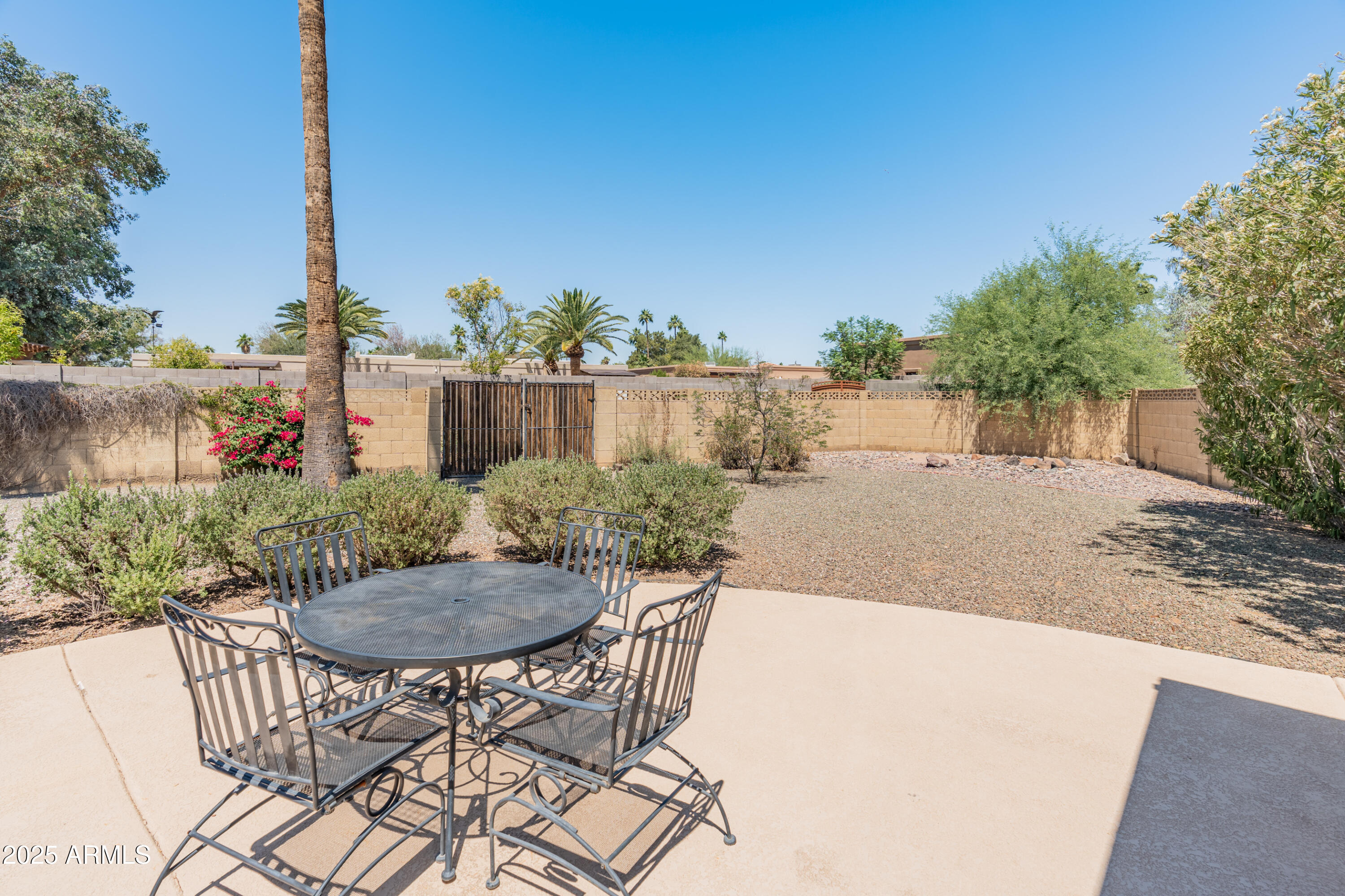 6931 East Pershing Avenue Scottsdale, AZ 85254 - Photo 50 of 59 a view of a chair and table in backyard