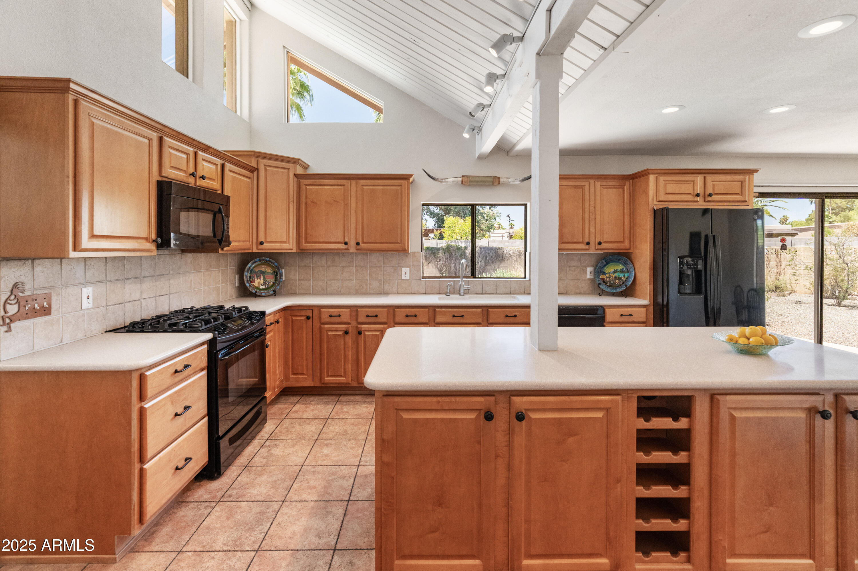 6931 East Pershing Avenue Scottsdale, AZ 85254 - Photo 6 of 59 a kitchen with kitchen island granite countertop a stove a sink and a refrigerator