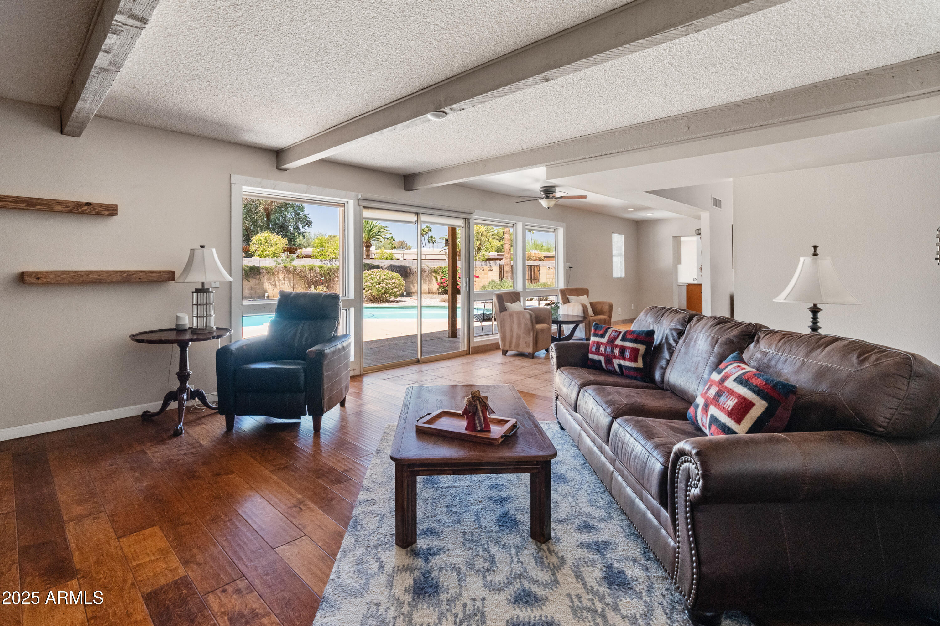 6931 East Pershing Avenue Scottsdale, AZ 85254 - Photo 9 of 59 a living room with furniture a rug and a floor to ceiling window
