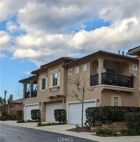 a front view of a house with garage and parking