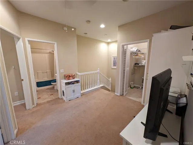 a view of a livingroom with furniture and a refrigerator