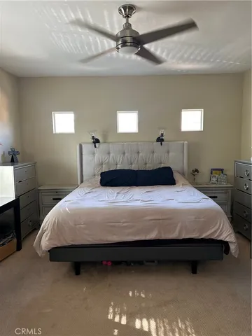 a bedroom with bed and window