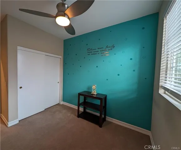 a room with window and a ceiling fan