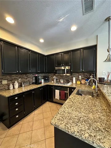 a kitchen with wooden cabinets and a sink