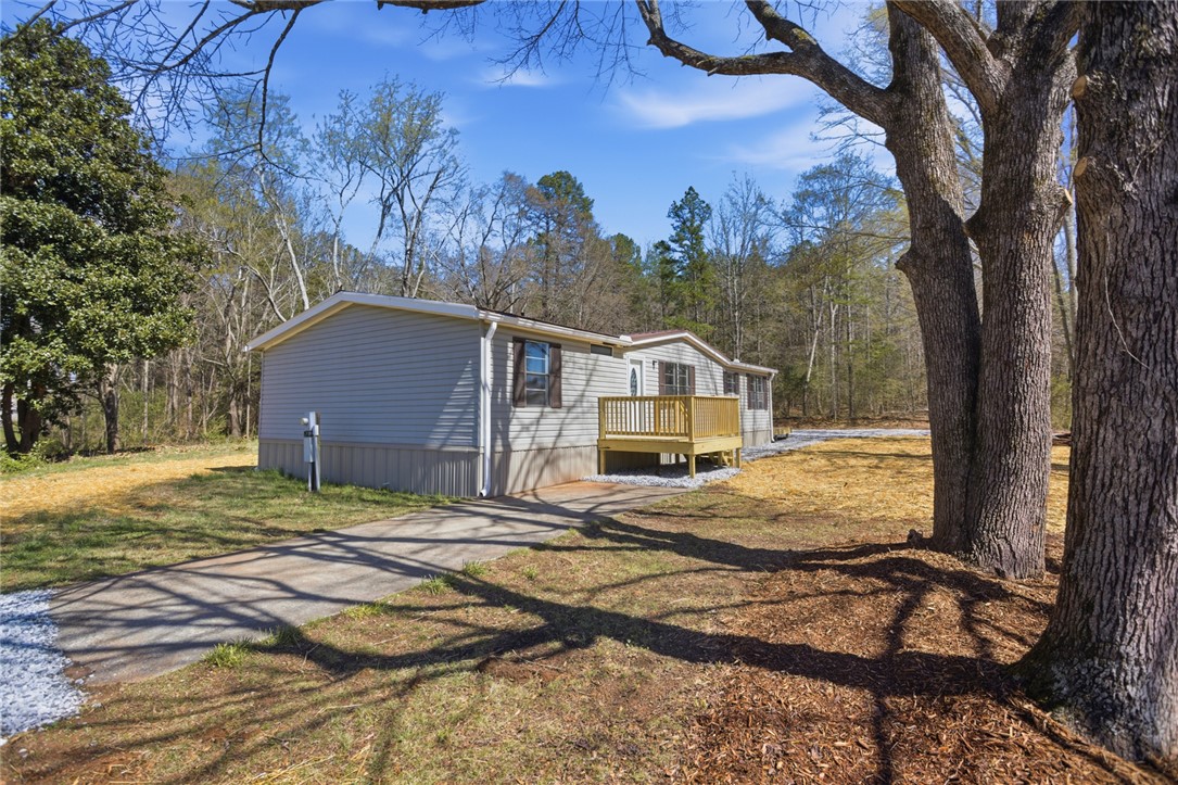 202 Greenbriar Drive Seneca, SC 29678 - Photo 1 of 37 This inviting home features a charming front porch, set amidst a peaceful, tree-lined landscape.