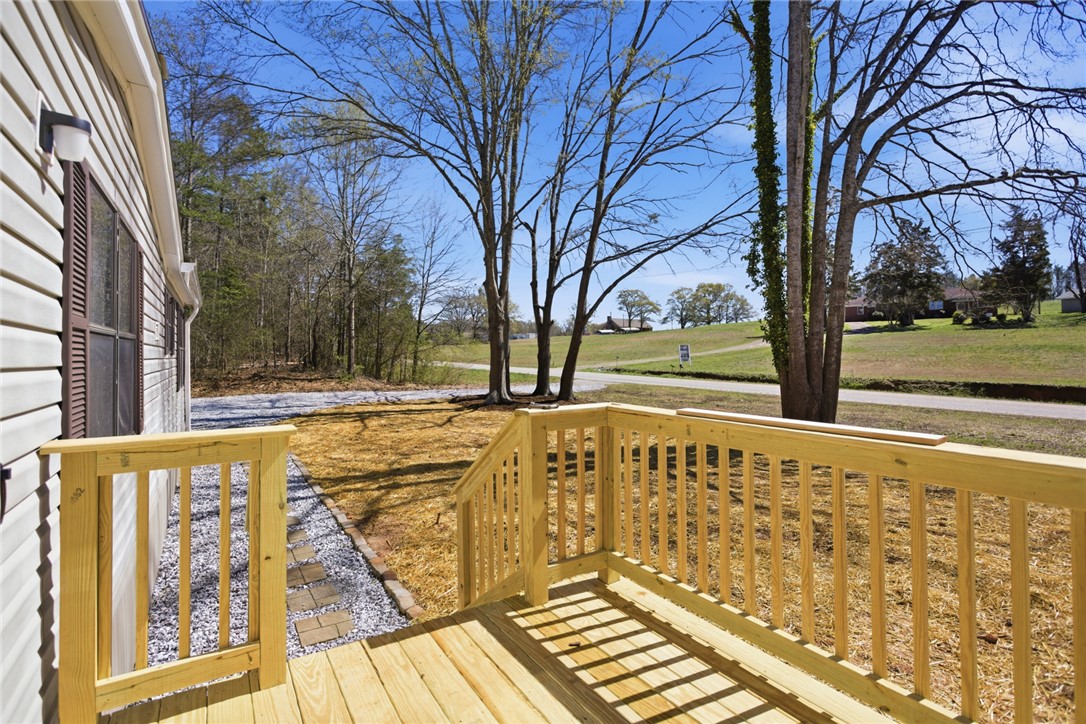 202 Greenbriar Drive Seneca, SC 29678 - Photo 12 of 37 This inviting exterior showcases a newly built deck overlooking serene natural surroundings.