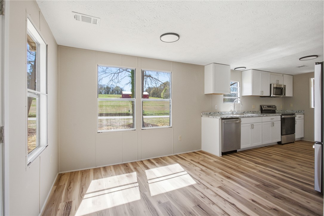 202 Greenbriar Drive Seneca, SC 29678 - Photo 26 of 37 Bright and airy living area with modern kitchen featuring sleek appliances and ample natural light.