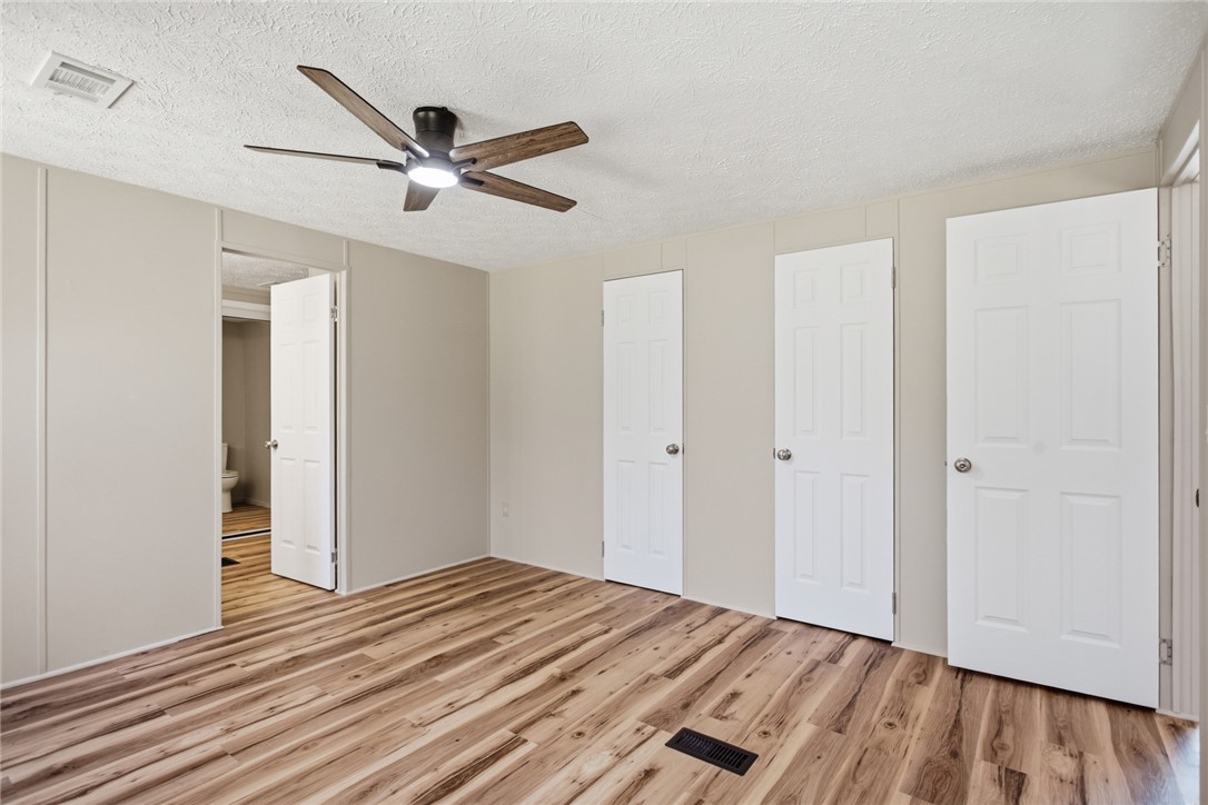 202 Greenbriar Drive Seneca, SC 29678 - Photo 29 of 37 This spacious bedroom features warm wood flooring and a modern ceiling fan, creating a comfortable ambiance.