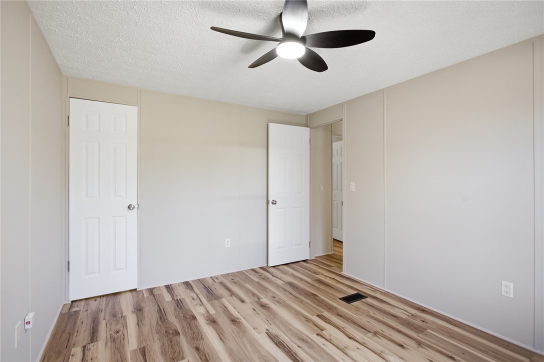 202 Greenbriar Drive Seneca, SC 29678 - Photo 37 of 37 This spacious room features beautiful wood flooring and a modern ceiling fan, offering comfort and style.
