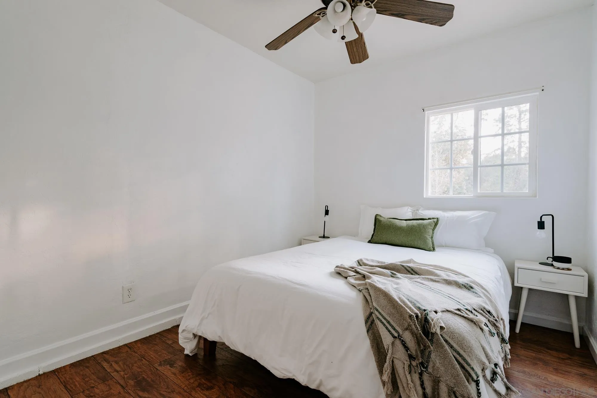 1560 South Grade Road Alpine, CA 91901 - Photo 40 of 48 a bedroom with a bed and wooden floor