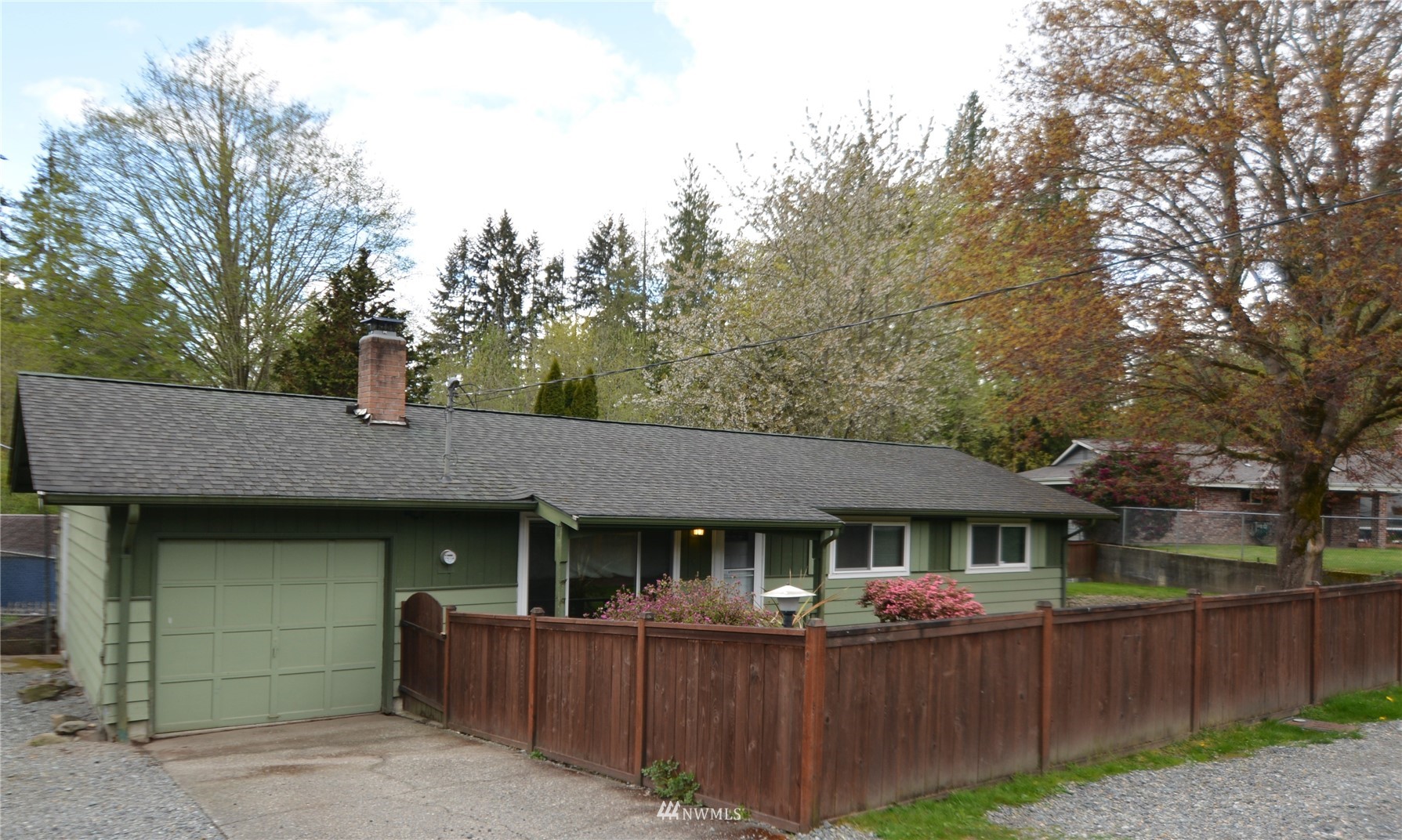 13243 Lake Kathleen Road Southeast Renton, WA 98059 - Photo 1 of 16 a front view of a house with a garage