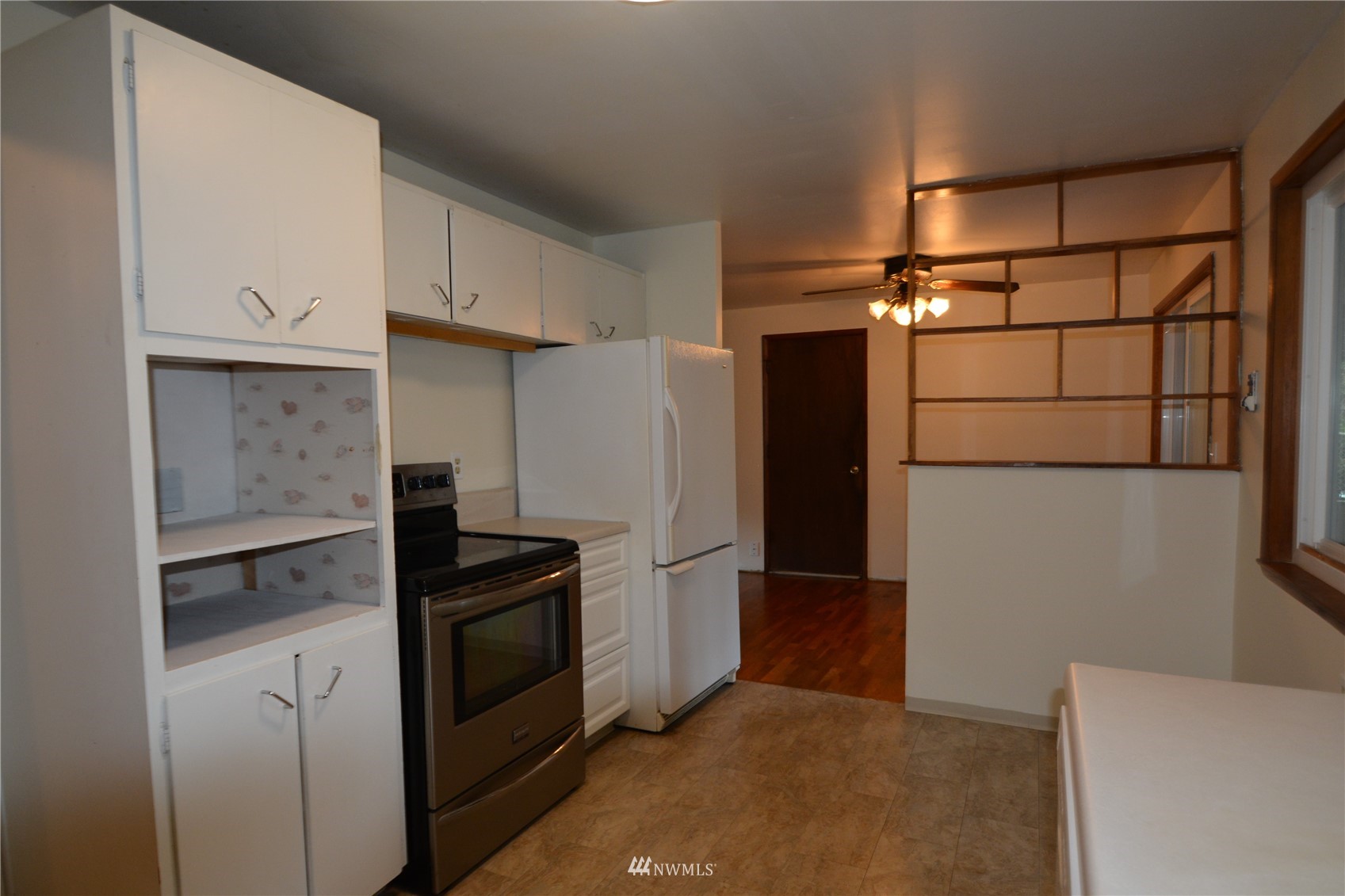 13243 Lake Kathleen Road Southeast Renton, WA 98059 - Photo 8 of 16 a kitchen with a refrigerator and cabinets