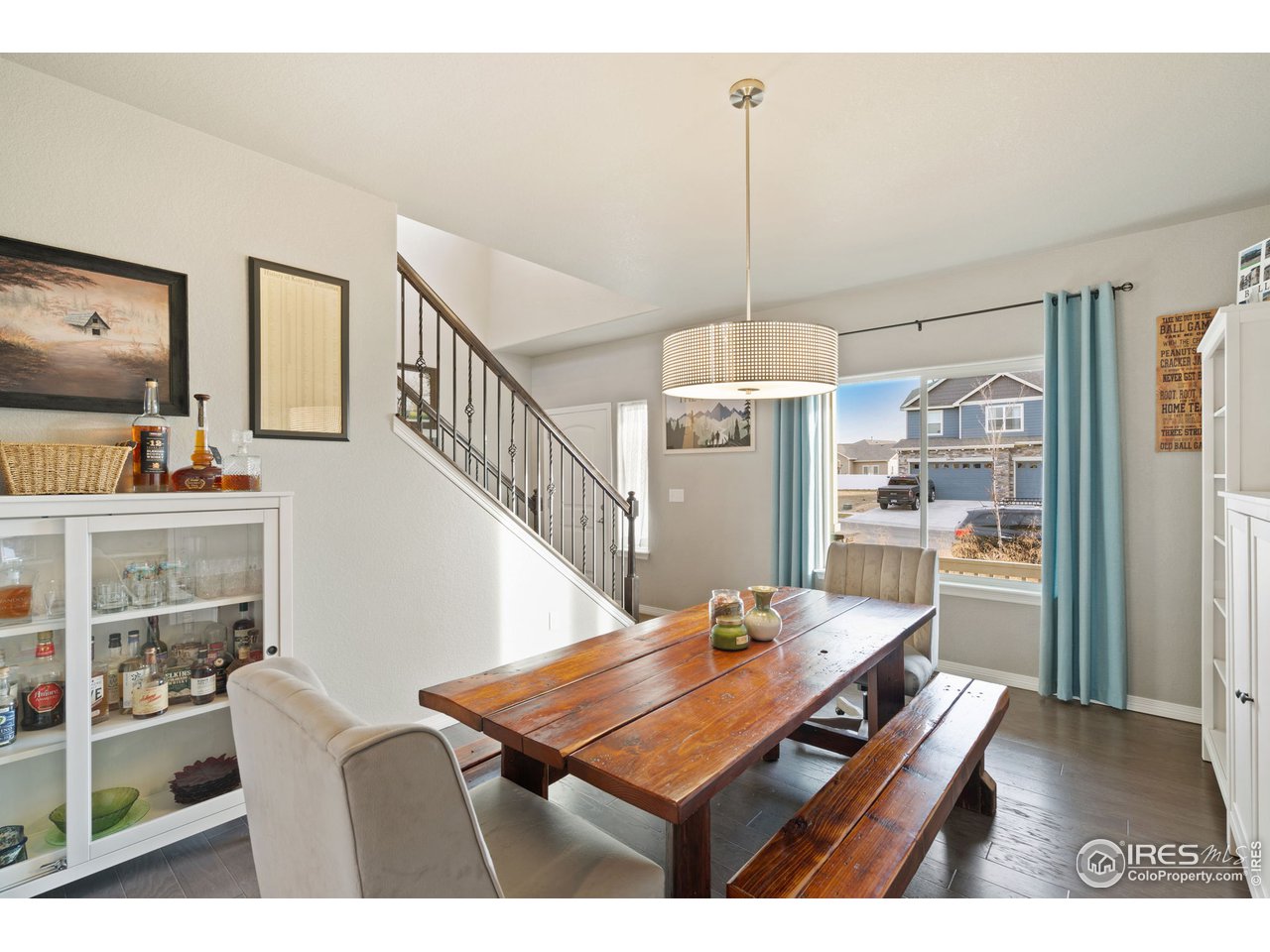 2499 Likens Drive Berthoud, CO 80513 - Photo 10 of 33 a dining room with furniture a chandelier and wooden floor