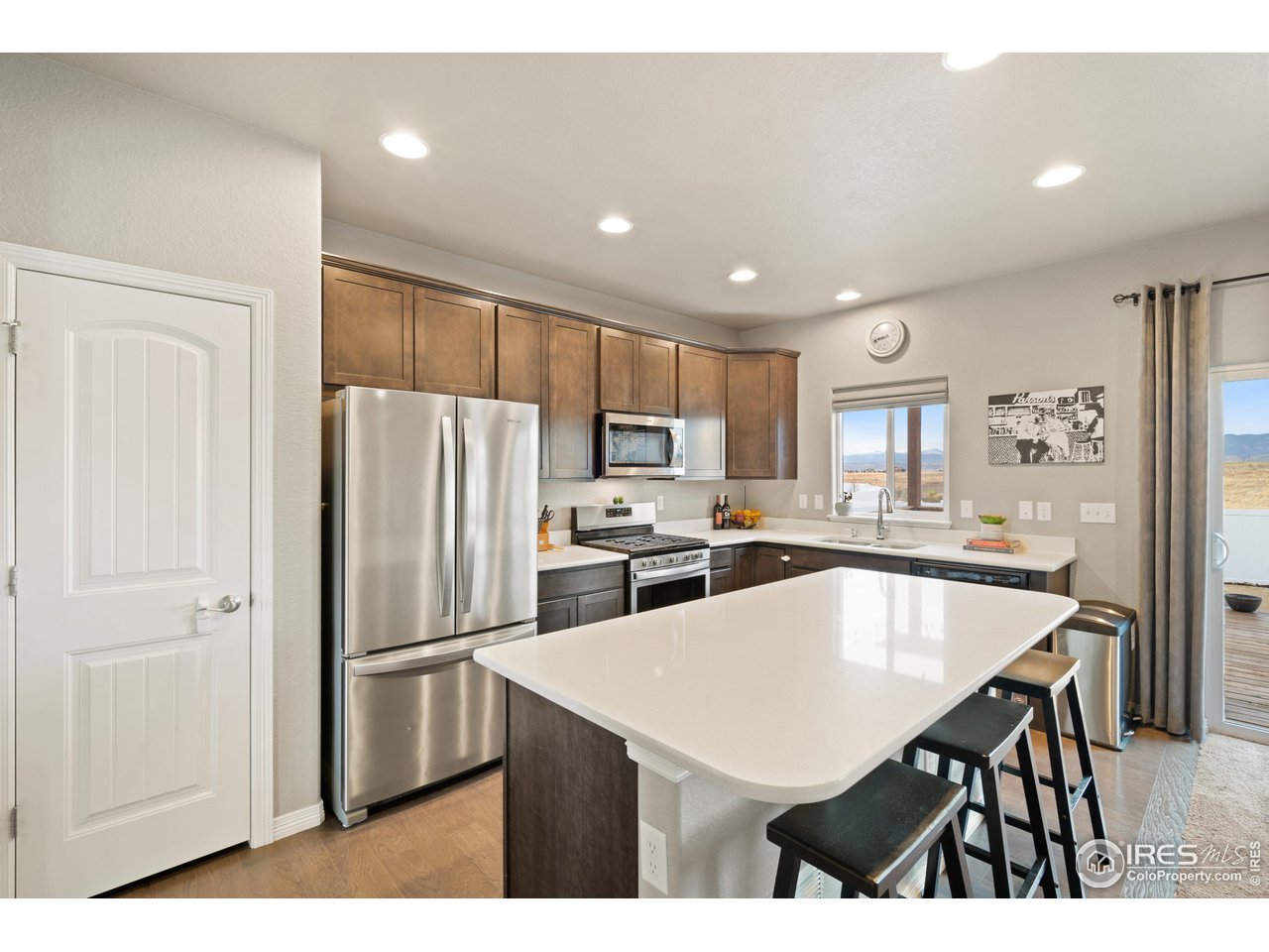 2499 Likens Drive Berthoud, CO 80513 - Photo 4 of 33 a kitchen with refrigerator cabinets and wooden floor