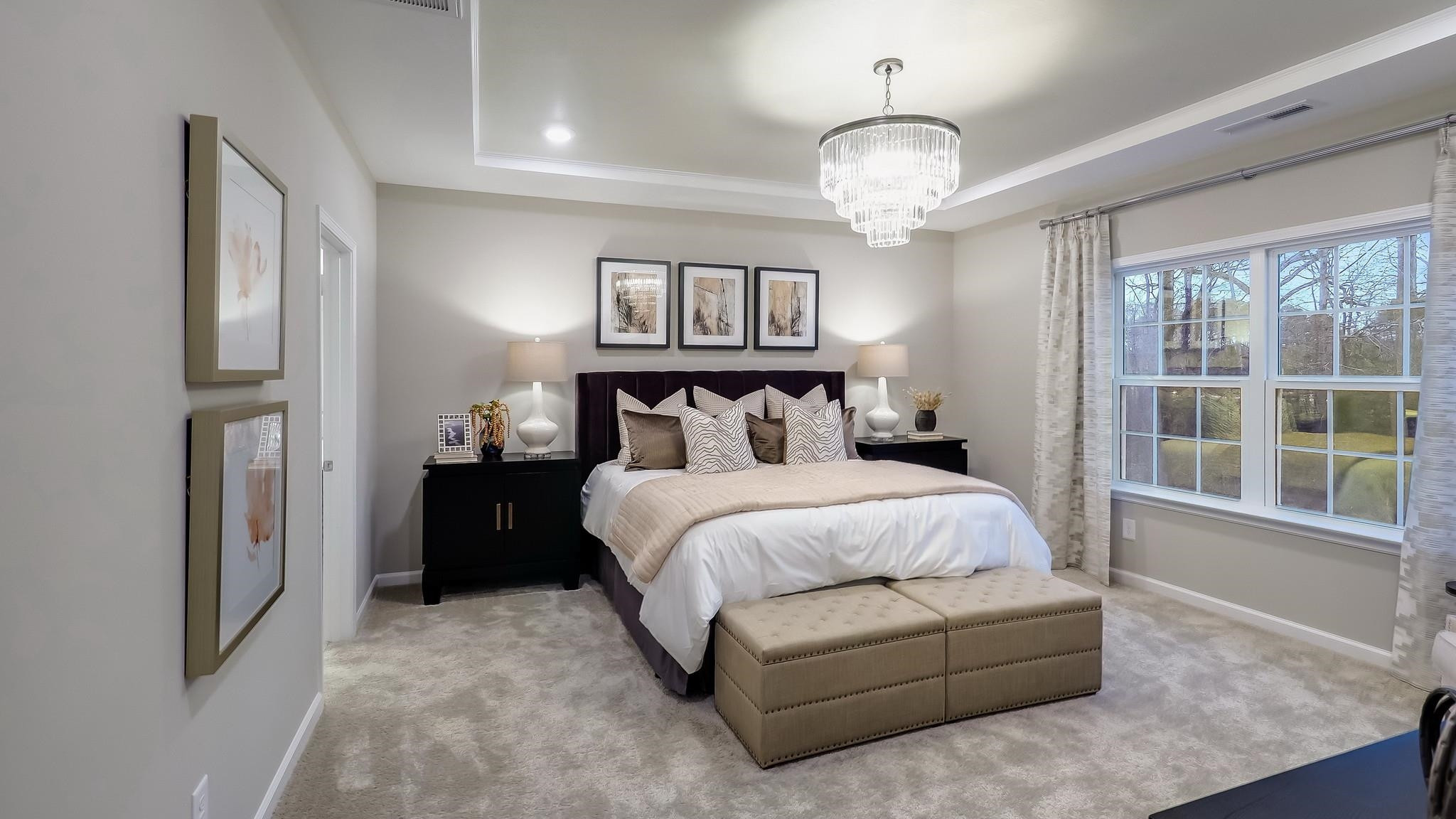 428 Salt Marsh Trail Raleigh, NC 27610 - Photo 22 of 35 a bedroom with a large bed and a chandelier