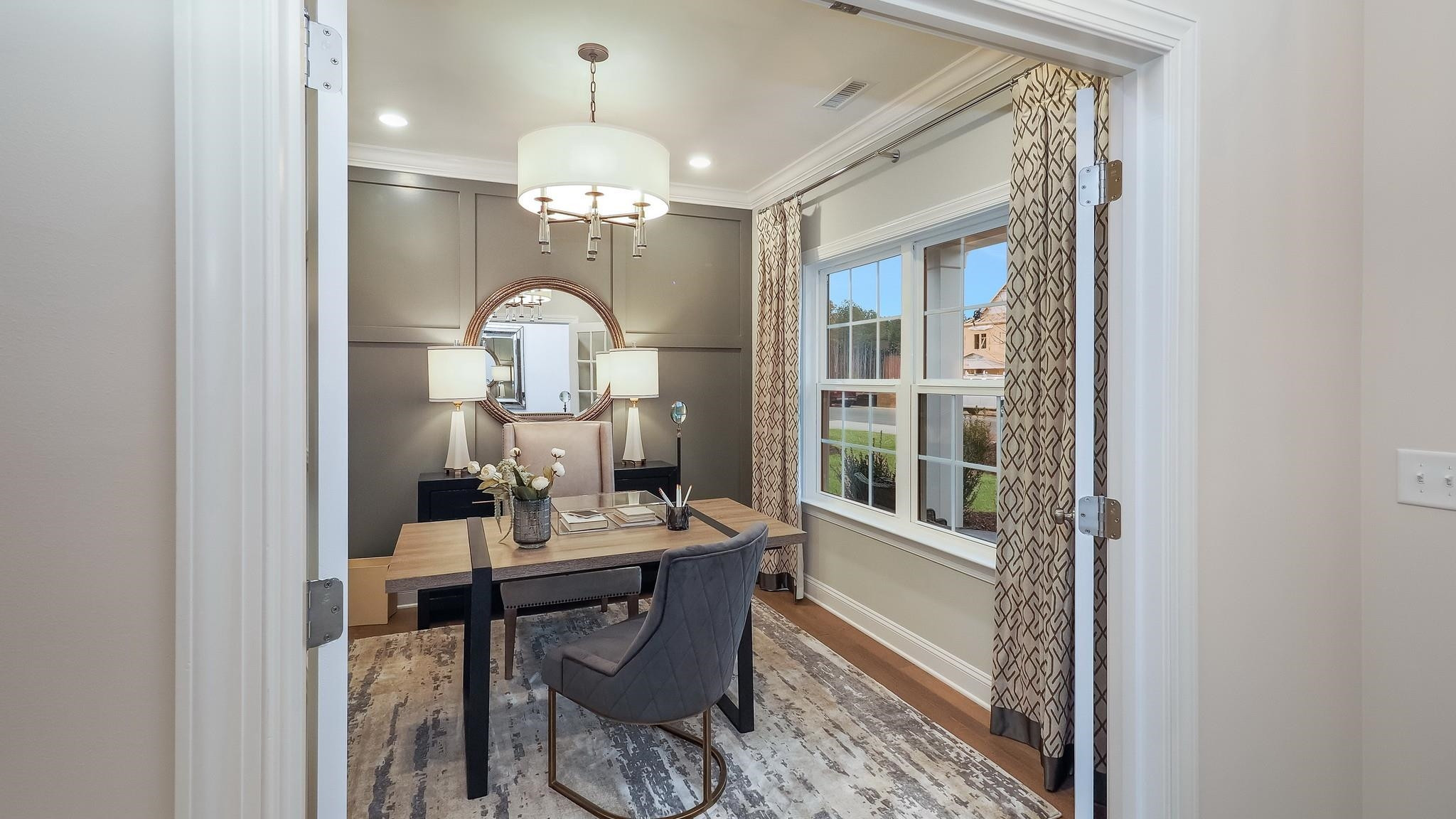 428 Salt Marsh Trail Raleigh, NC 27610 - Photo 8 of 35 a view of a dining room with furniture a chandelier and wooden floor