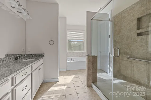 a bathroom with a granite countertop sink a toilet and shower