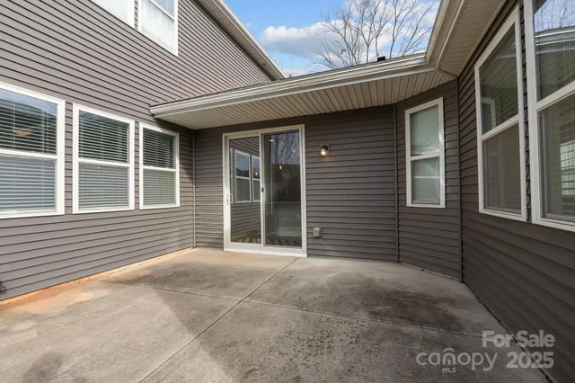 a view of a house with a large window and brick walls