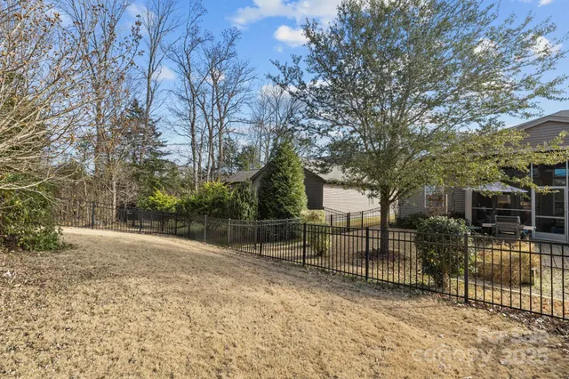 a view of outdoor space with iron fence