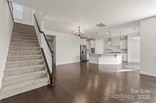 a view of a kitchen with furniture and wooden floor