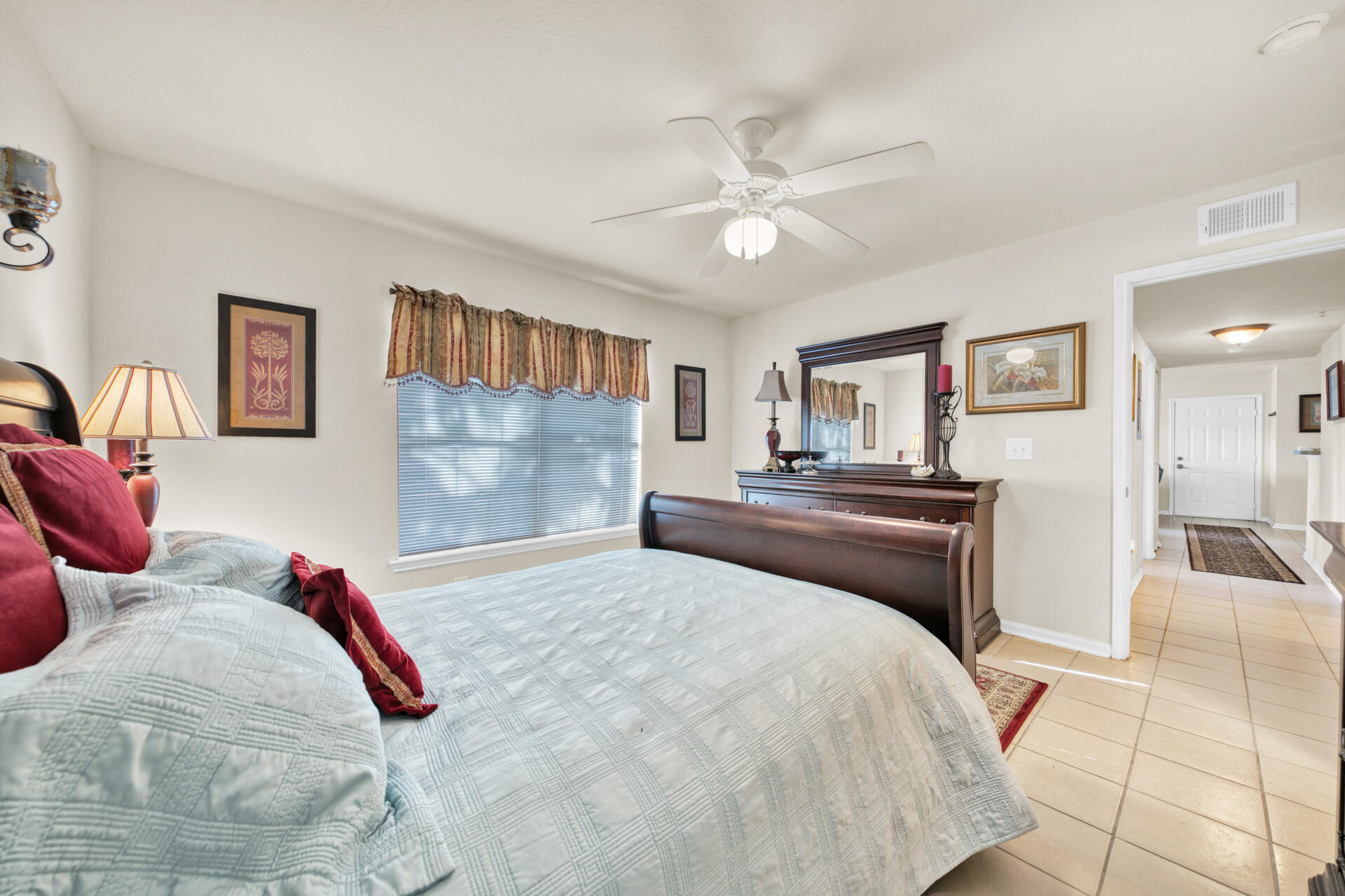 4010 Dancing Cloud Court, Unit 387 Destin, FL 32541 - Photo 11 of 20 a bedroom with a large bed and a chandelier