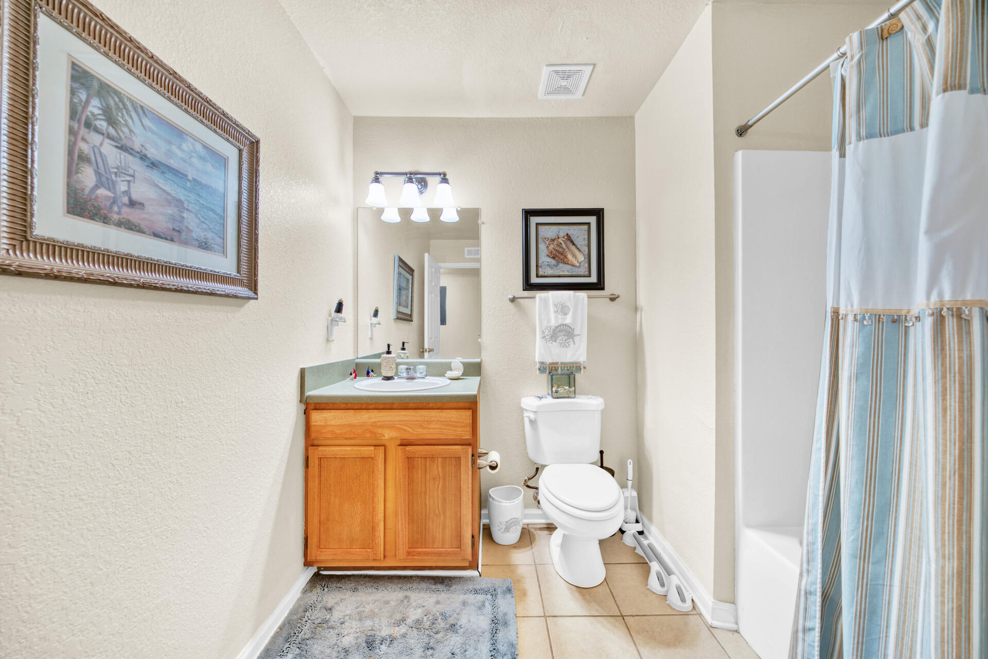 4010 Dancing Cloud Court, Unit 387 Destin, FL 32541 - Photo 13 of 20 a bathroom with a sink a toilet and a mirror
