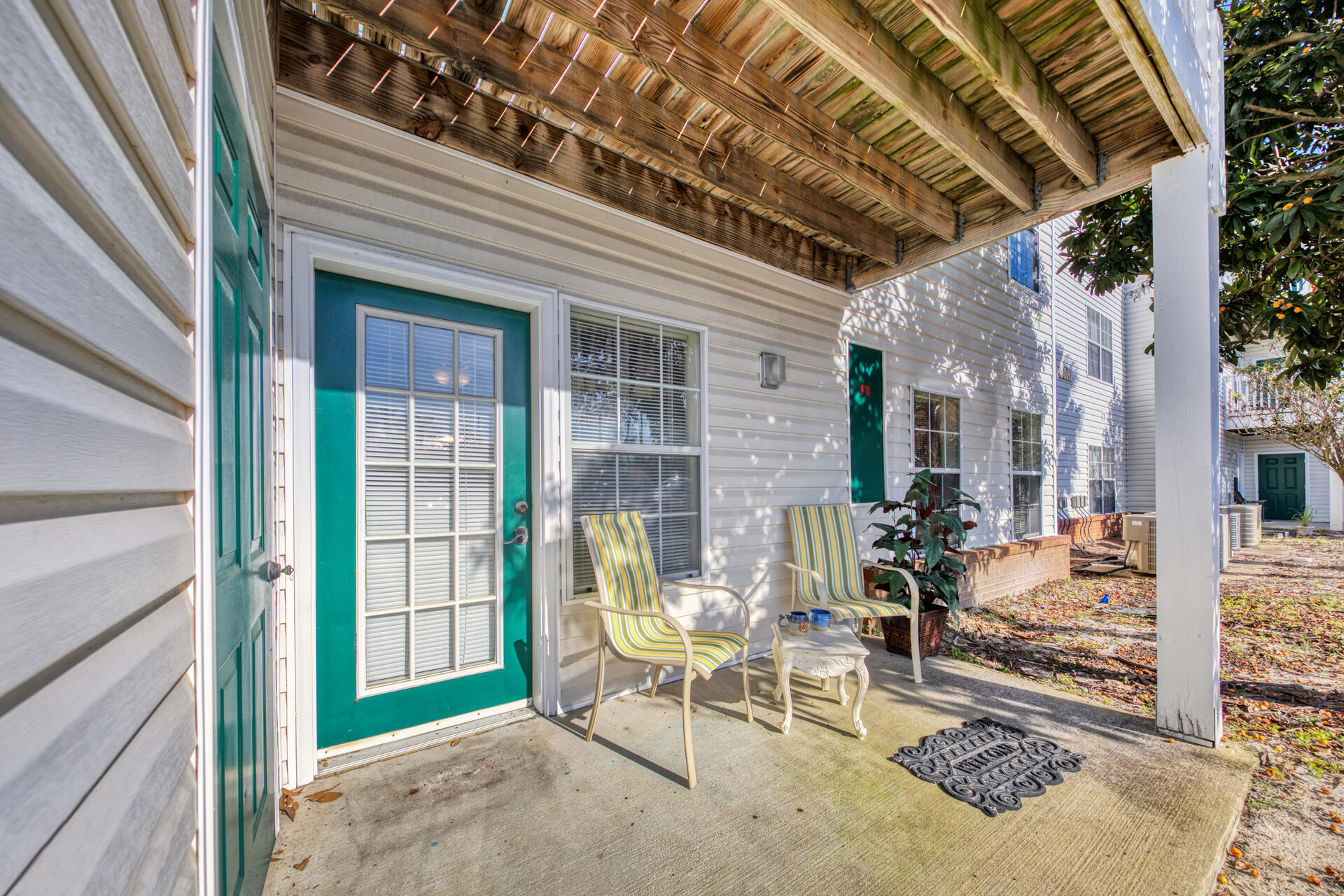 4010 Dancing Cloud Court, Unit 387 Destin, FL 32541 - Photo 17 of 20 a view of a porch with chairs and potted plants