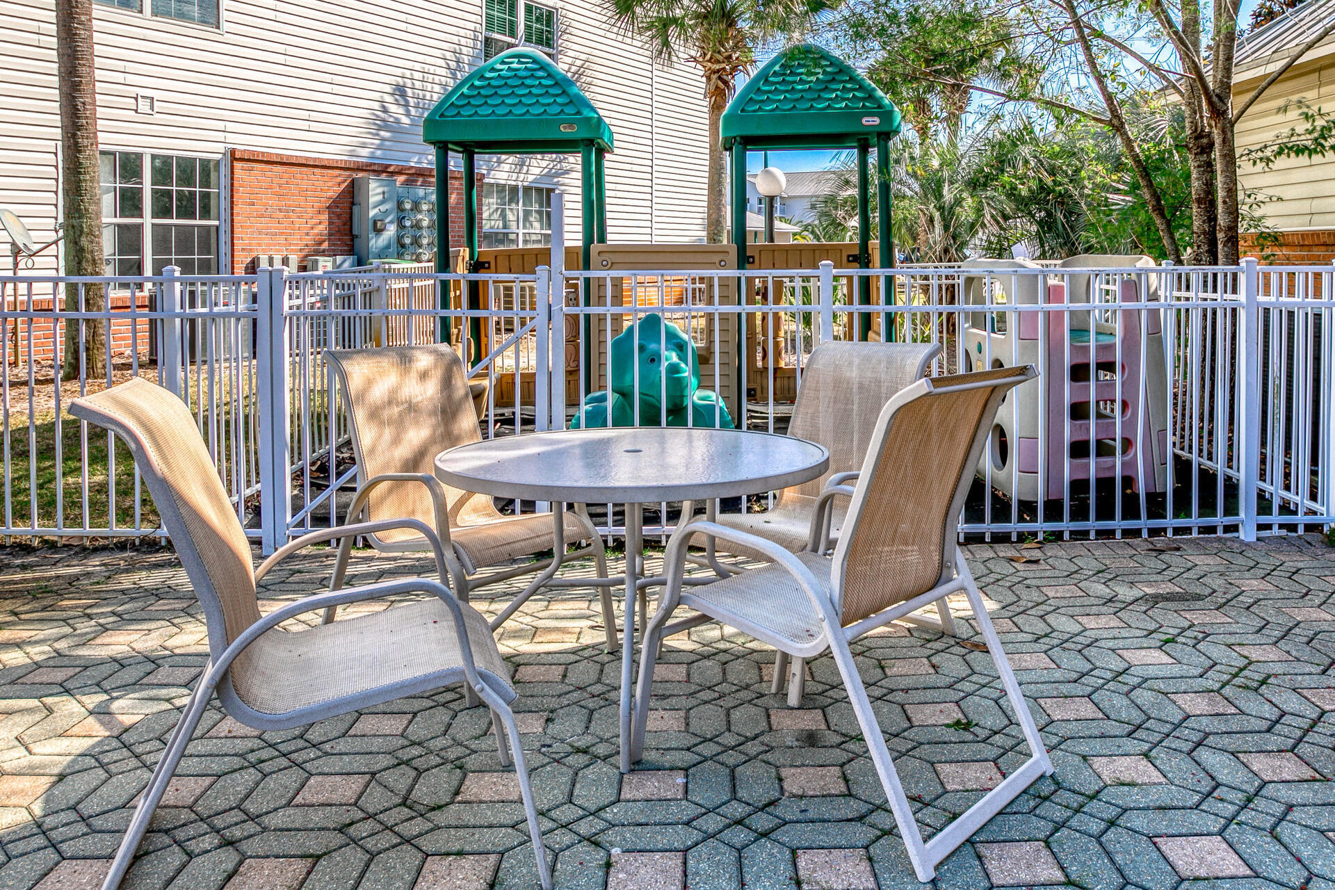 4010 Dancing Cloud Court, Unit 387 Destin, FL 32541 - Photo 20 of 20 a view of a patio with a table chairs and a floor to ceiling window