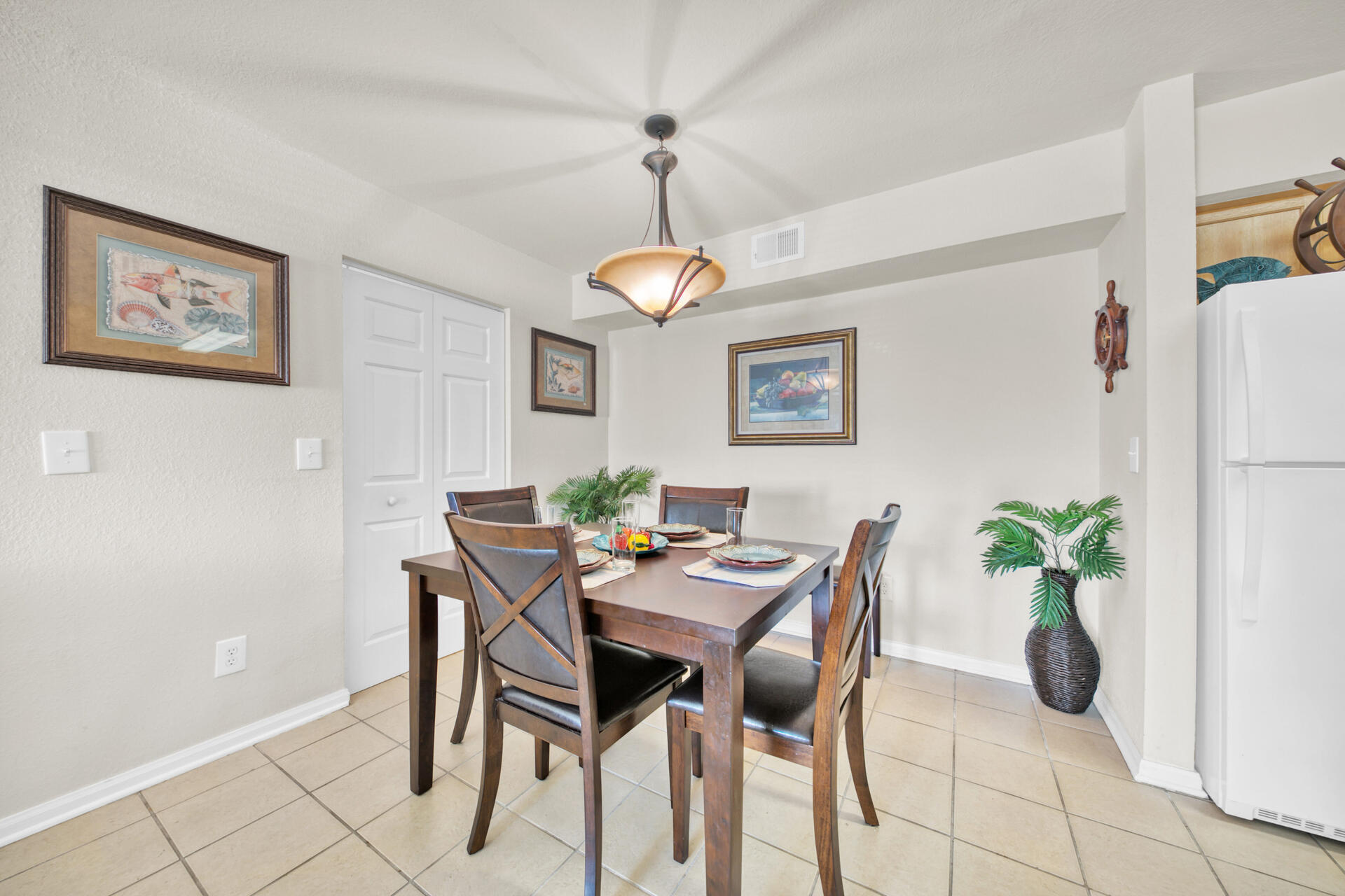 4010 Dancing Cloud Court, Unit 387 Destin, FL 32541 - Photo 5 of 20 a view of a dining room with furniture and a potted plant