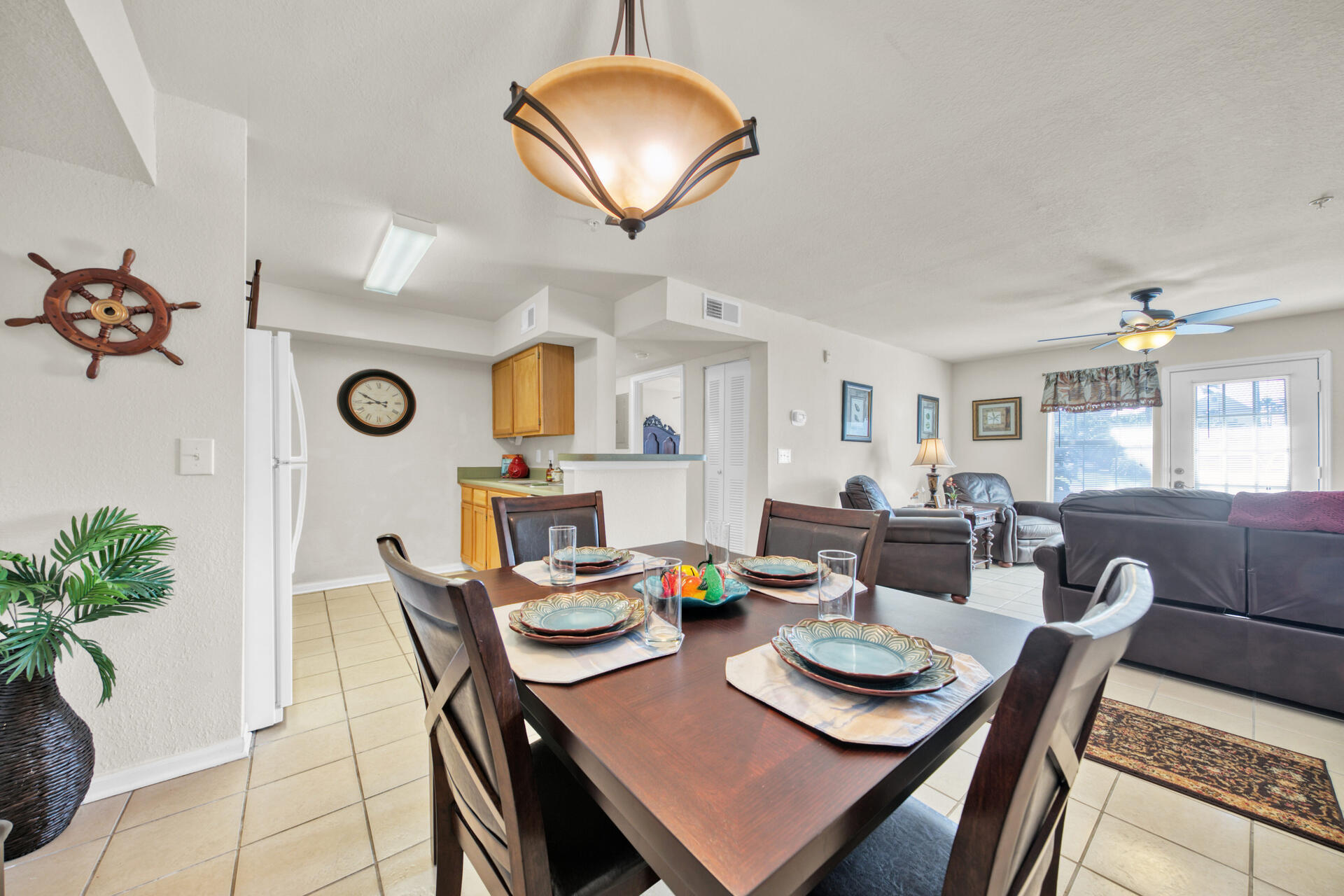 4010 Dancing Cloud Court, Unit 387 Destin, FL 32541 - Photo 6 of 20 a view of a dining room with furniture and a potted plant