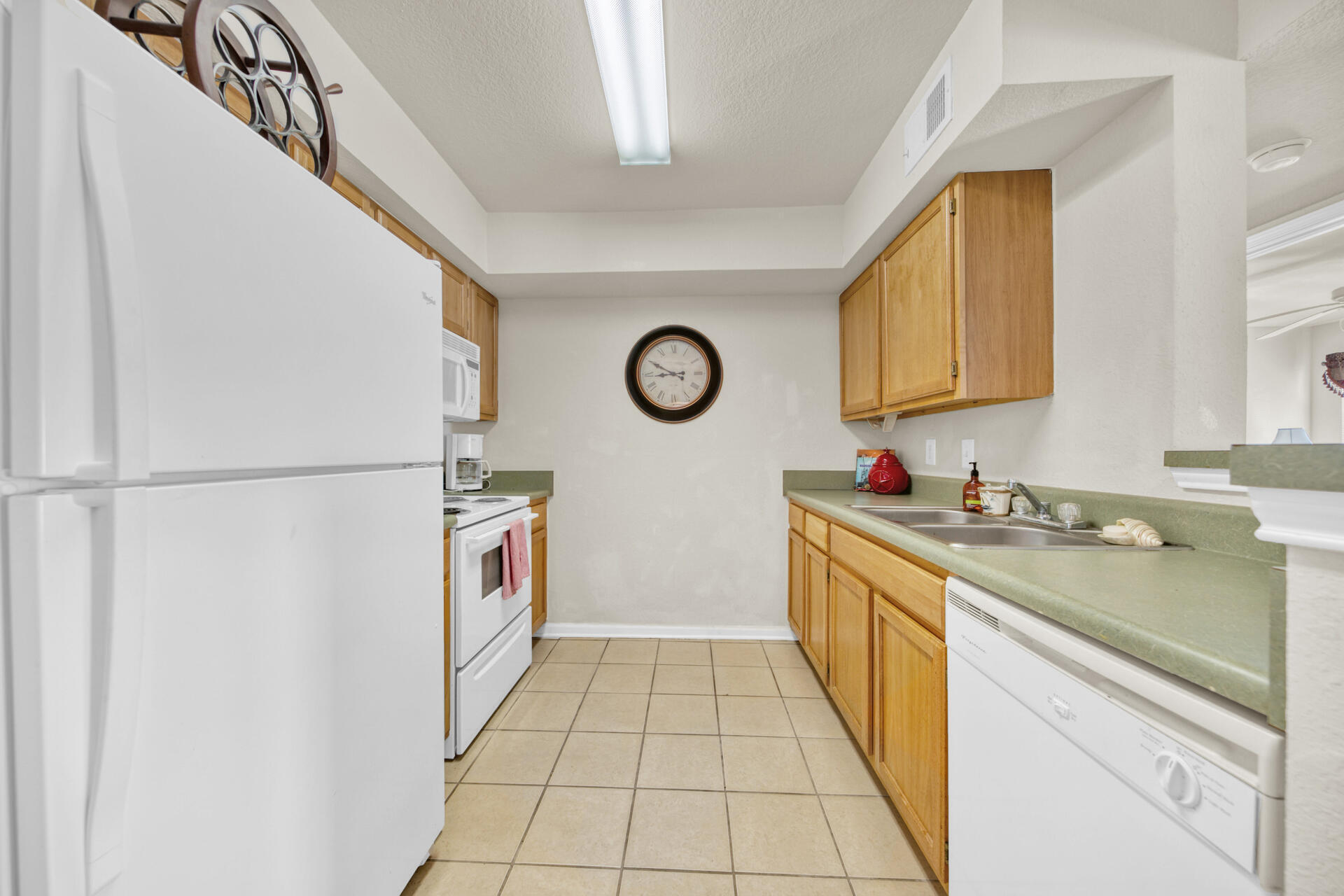 4010 Dancing Cloud Court, Unit 387 Destin, FL 32541 - Photo 7 of 20 a kitchen with stainless steel appliances granite countertop a sink and dishwasher with wooden floor