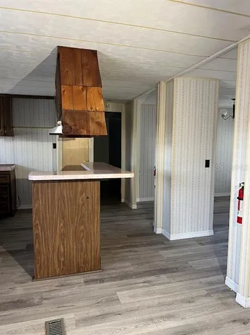 an entryway with wooden floor and cabinet