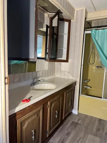 a bathroom with a sink vanity and a mirror