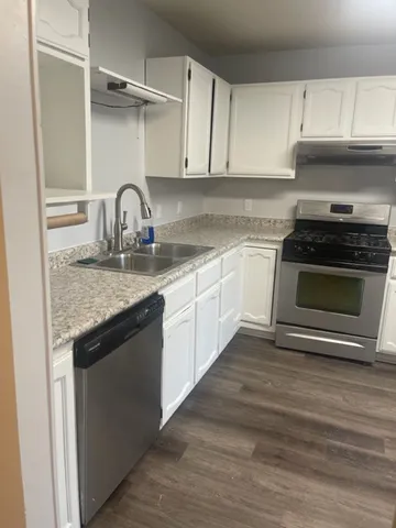 a kitchen with granite countertop a stove and a sink
